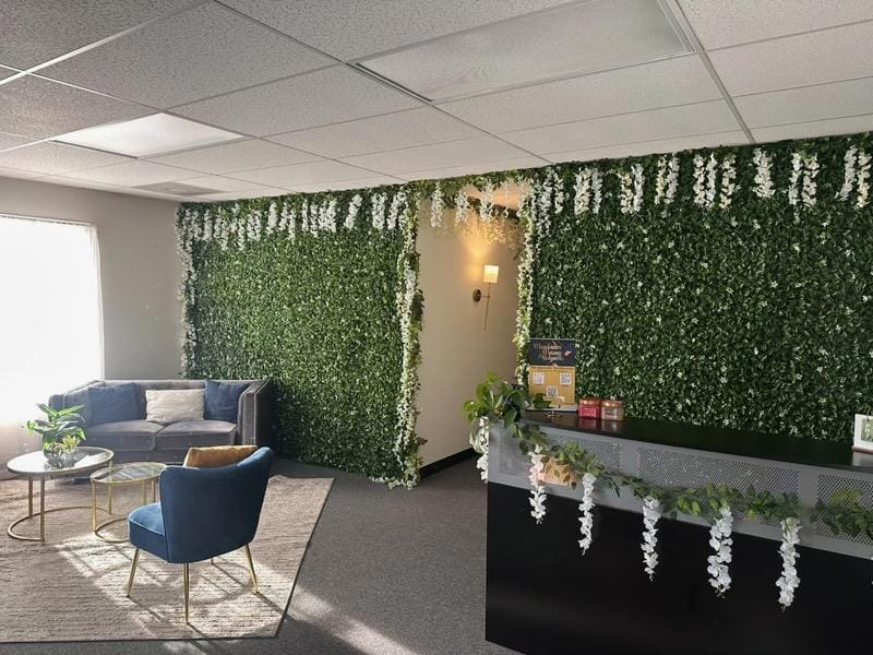 The greenery wall and lounge at Mountaineer Massage & Bodyworks